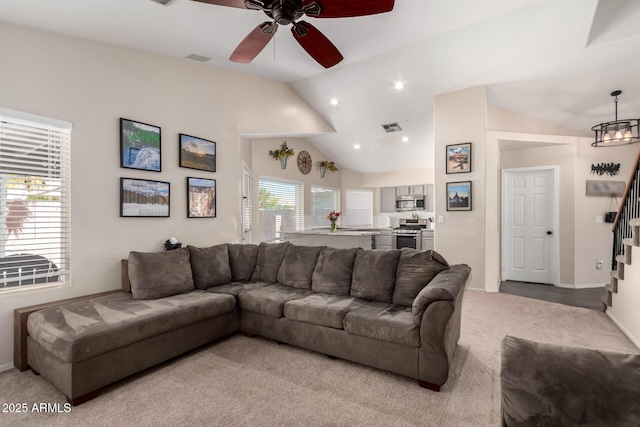 living room with stairs, lofted ceiling, light colored carpet, visible vents, and ceiling fan with notable chandelier