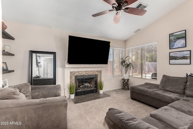 living room with visible vents, a ceiling fan, light colored carpet, lofted ceiling, and a fireplace