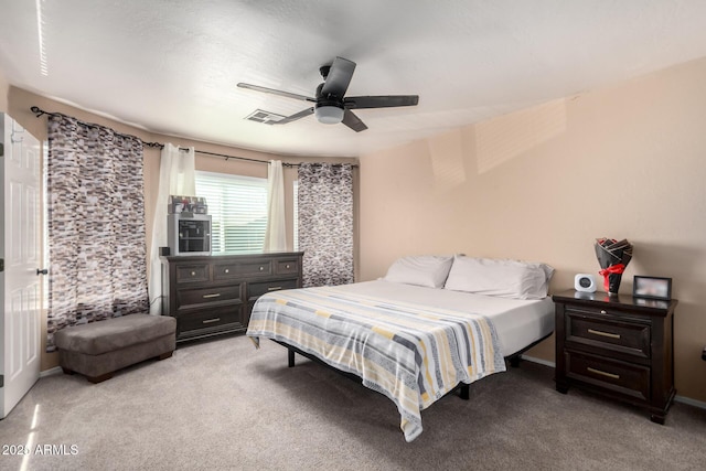 bedroom featuring a ceiling fan, visible vents, and carpet flooring