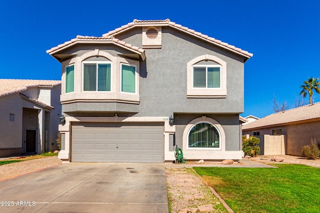 mediterranean / spanish home with a garage, driveway, a tile roof, and stucco siding