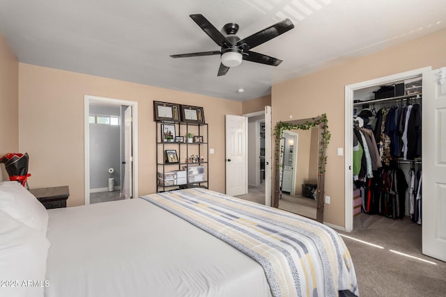 carpeted bedroom featuring ensuite bathroom, a closet, and a walk in closet