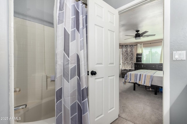 full bath featuring a textured wall, shower / bath combo, connected bathroom, and ceiling fan