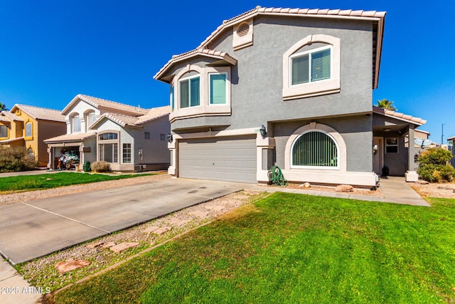 mediterranean / spanish-style home with an attached garage, a front yard, and stucco siding