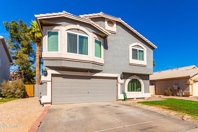 view of front of house featuring concrete driveway, a tiled roof, an attached garage, fence, and stucco siding