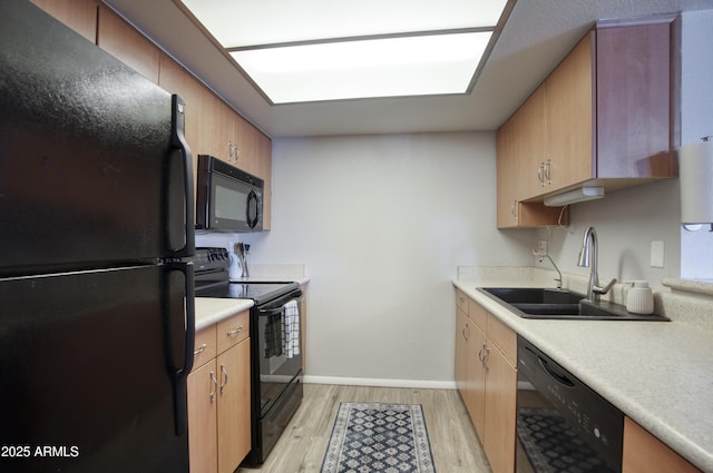 17032 N 16th Dr Unit 8, Phoenix, AZ 85023 - kitchen featuring black appliances, a sink, light wood-style flooring, light countertops, and baseboards