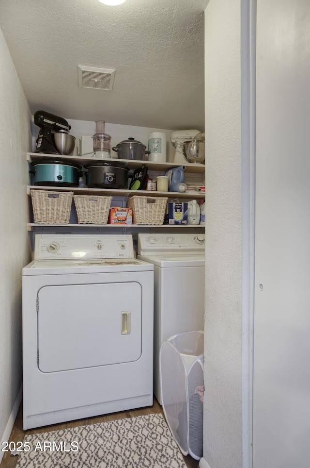 17032 N 16th Dr Unit 8, Phoenix, AZ 85023 - washroom with washer and clothes dryer, a textured ceiling, and baseboards