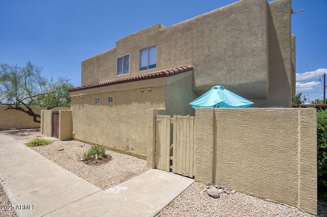 17032 N 16th Dr Unit 8, Phoenix, AZ 85023 - view of home's exterior featuring stucco siding and a gate