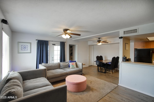 17032 N 16th Dr Unit 8, Phoenix, AZ 85023 - living room with light wood-style flooring, a ceiling fan, and baseboards