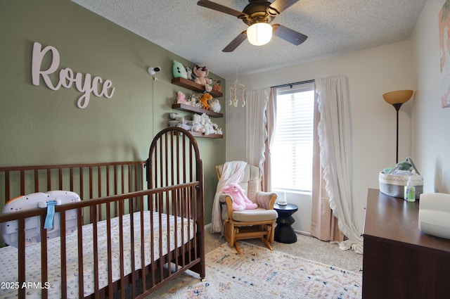 17032 N 16th Dr Unit 8, Phoenix, AZ 85023 - carpeted bedroom featuring a crib and a textured ceiling
