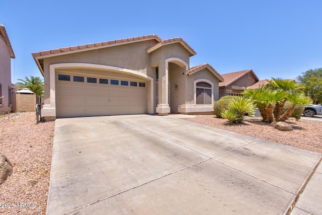 878 E Mountain View Rd, San Tan Valley, AZ 85143 - mediterranean / spanish house featuring concrete driveway, an attached garage, a tiled roof, and stucco siding