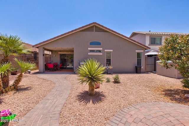 878 E Mountain View Rd, San Tan Valley, AZ 85143 - back of house featuring stucco siding, a patio area, and a gate