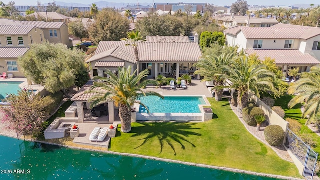 view of swimming pool featuring a fenced in pool, a residential view, a lawn, and a patio