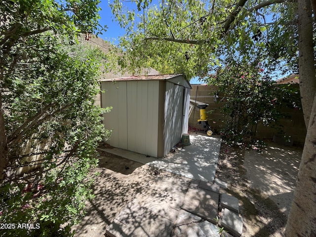 view of shed with a fenced backyard