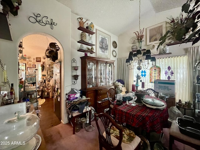 dining area featuring arched walkways, carpet floors, a textured ceiling, and lofted ceiling