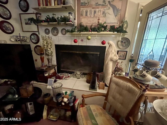 living room featuring a tile fireplace