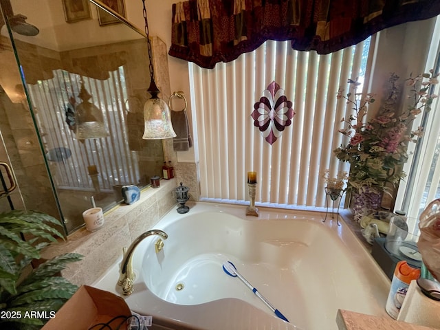 bathroom with a whirlpool tub and a shower