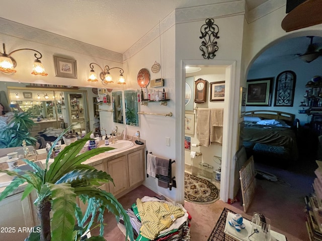bathroom with crown molding and vanity