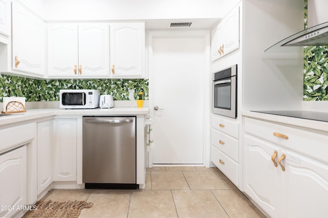 kitchen with light tile patterned flooring, white cabinetry, stainless steel appliances, and exhaust hood