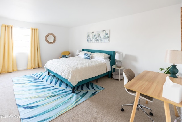 bedroom featuring light carpet