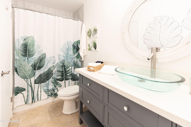 bathroom with tile patterned flooring, vanity, and toilet