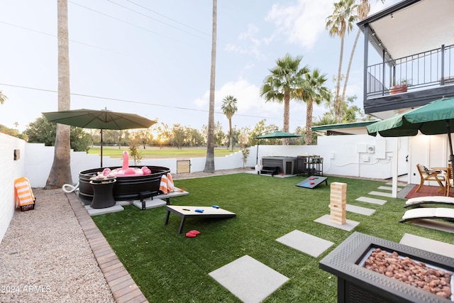 view of yard featuring a hot tub, an outdoor fire pit, and central air condition unit