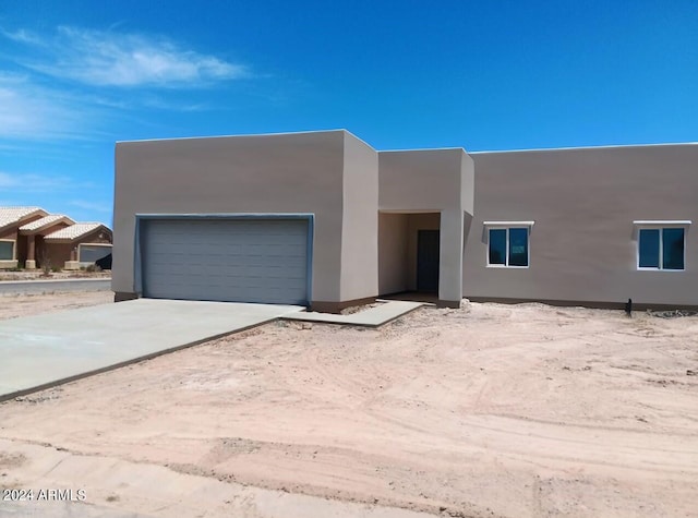 southwest-style home with a garage