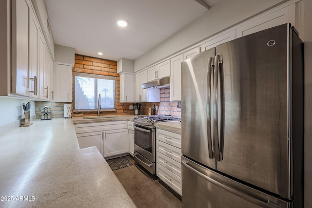 kitchen with tasteful backsplash, stainless steel appliances, sink, and white cabinets