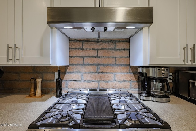 details featuring stovetop and white cabinets