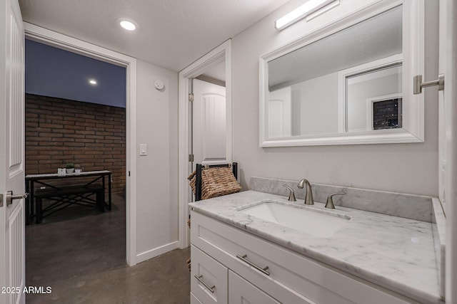 bathroom featuring vanity and concrete flooring