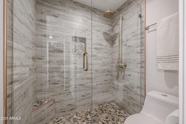 bathroom with an enclosed shower and toilet