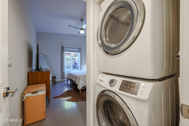 clothes washing area featuring stacked washer / drying machine and ceiling fan