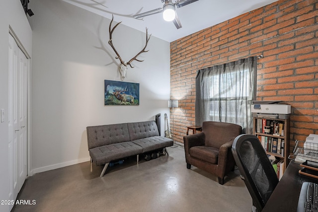 office featuring brick wall, concrete floors, and ceiling fan