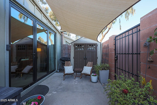 view of patio / terrace featuring a storage shed and a grill