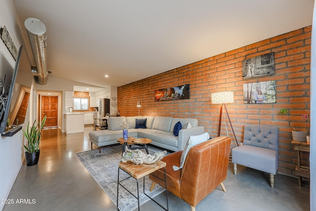 living room featuring concrete floors and brick wall