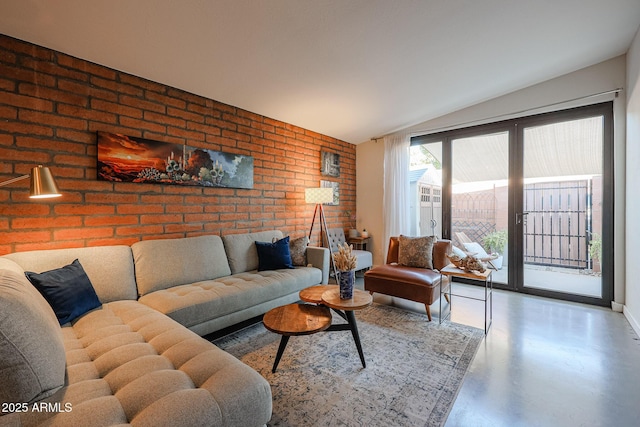 living room featuring brick wall and concrete floors