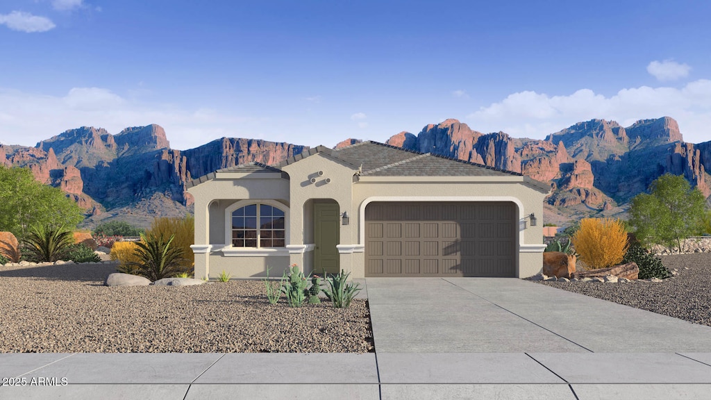 24264 W Hacienda Ave, Buckeye, AZ 85326 - mediterranean / spanish home with a garage, stucco siding, driveway, and a mountain view