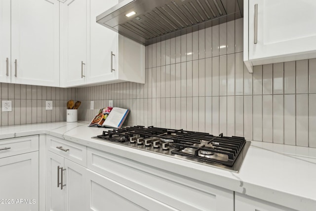 kitchen featuring white cabinetry, backsplash, custom exhaust hood, and stainless steel gas stovetop
