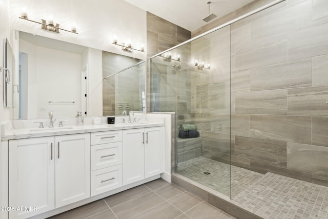 bathroom featuring a sink, tile patterned floors, and a stall shower