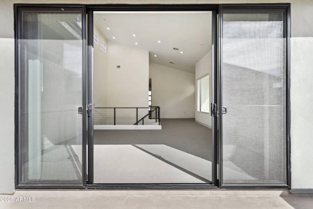 interior space with recessed lighting, carpet flooring, and lofted ceiling