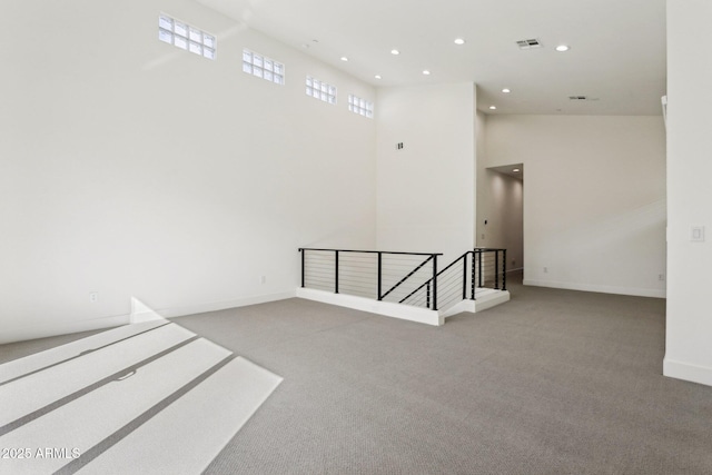 spare room with baseboards, carpet flooring, recessed lighting, and visible vents