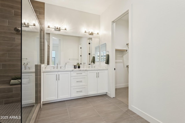 full bathroom with double vanity, a sink, walk in shower, and tile patterned flooring