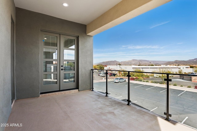 balcony featuring a mountain view and french doors