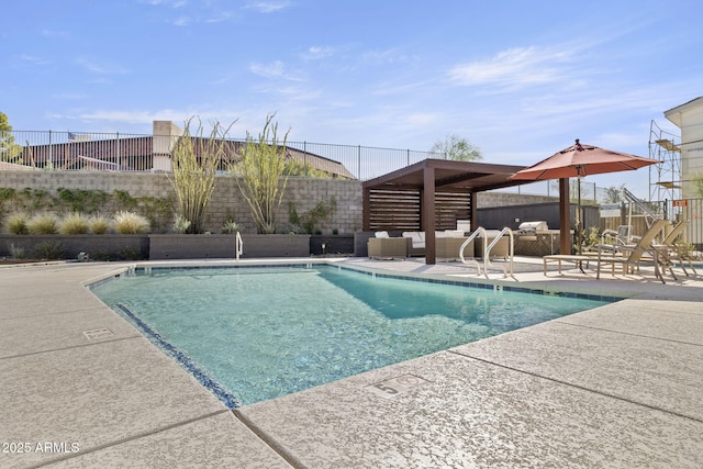 pool with outdoor lounge area, a fenced backyard, and a patio area