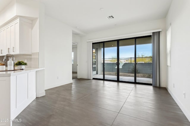 interior space with baseboards and visible vents