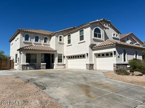 mediterranean / spanish-style house with a garage