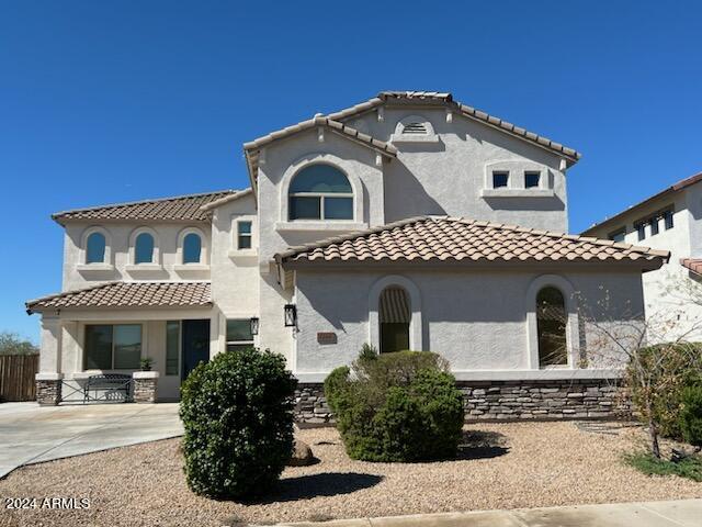 mediterranean / spanish home with a patio area