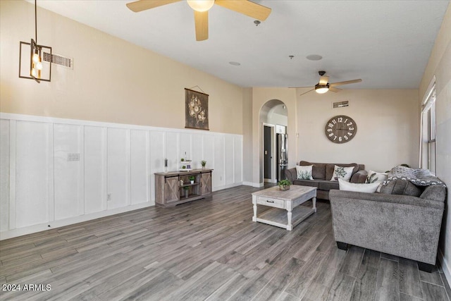 living room featuring ceiling fan and hardwood / wood-style floors