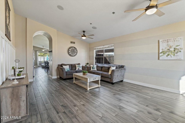 living room featuring hardwood / wood-style floors, ceiling fan, and lofted ceiling