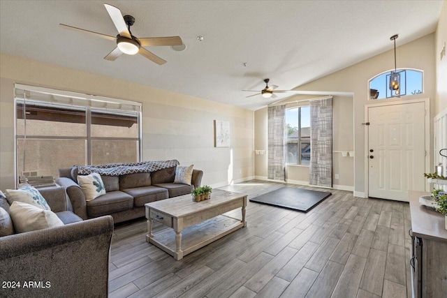 living room featuring ceiling fan and lofted ceiling