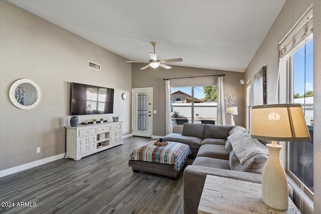 living room featuring ceiling fan, dark wood-type flooring, a healthy amount of sunlight, and vaulted ceiling